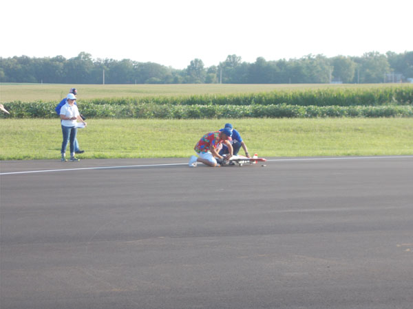 Todd starting his engine. His father, Jim, is launching for him.