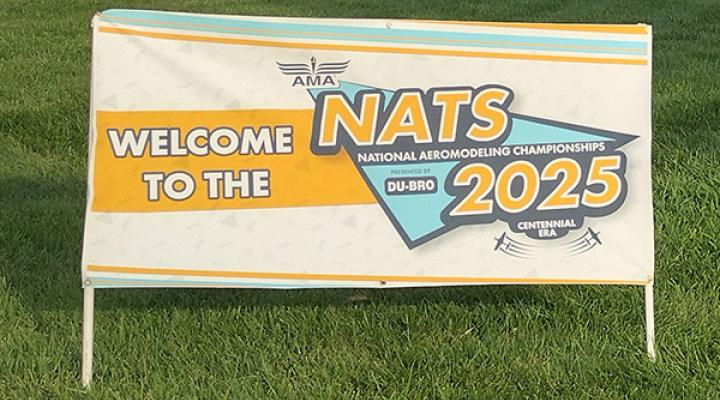Welcome sign for the National Aeromodeling Championships 2025 on a lawn.